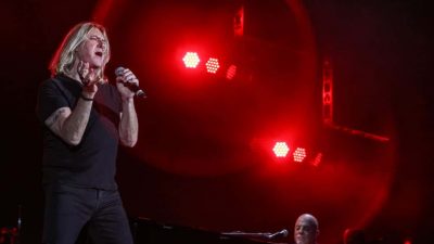 Joe Elliott of Def Leppard performs 'Pour Some Sugar On Me' with Billy Joel at Fenway Park in Boston, Massachusetts.