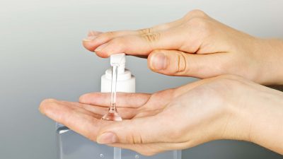individual using hand sanitizer