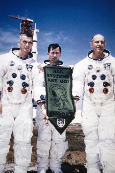 3 Astronauts from APOLLO 10 mission holding a banner with snoopy on it