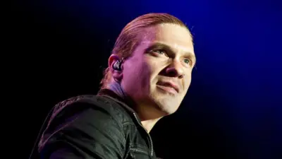 Brent Smith of Shinedown against a black and blue background at Rockstar Uproar Festival on September 25 2012 in Nampa^ Idaho.