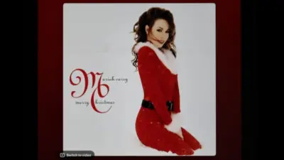Mariah Carey's classic holiday album Merry Christmas from Spotify's interface on an Apple iPad. The currently selected track is "All I Want for Christmas Is You".