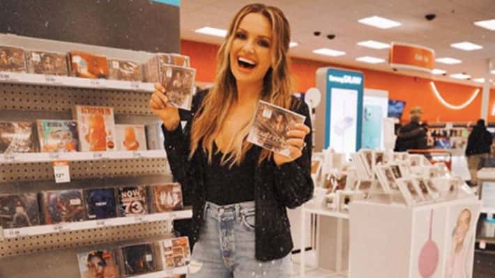 Carly Pearce at Target holding her self-titled album "Carly Pearce"
