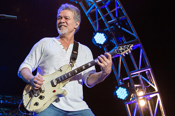Eddie Van Halen playing guitar in concert