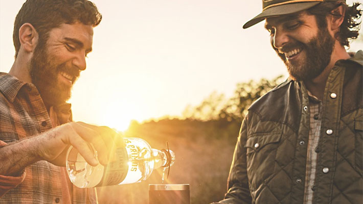 Thomas Rhett and his cousin pouring a tequila bottle