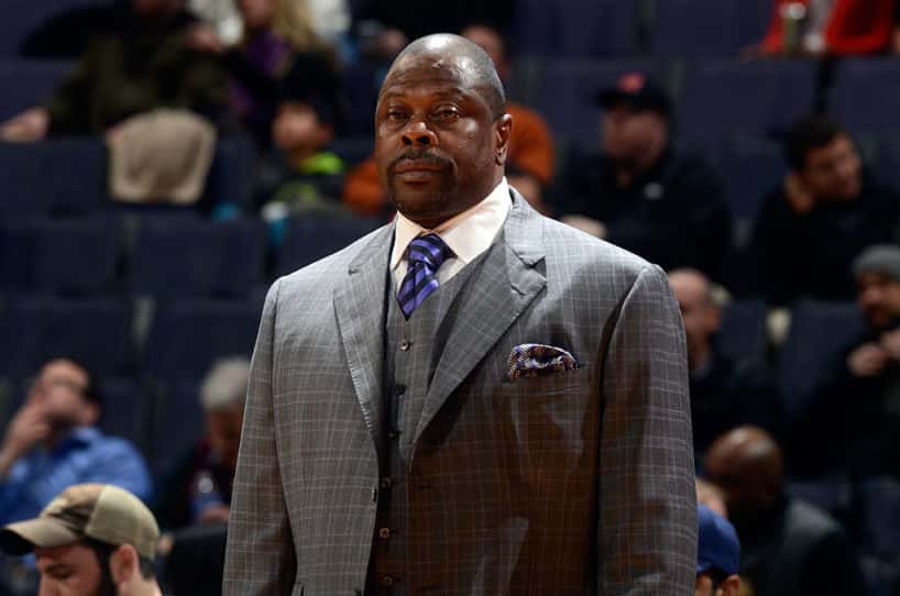 Patrick Ewing standing up wearing a suit