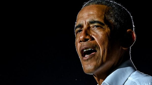 TOPSHOT - Former US President Barack Obama speaks at a drive-in rally as he campaigns for Democratic presidential candidate former Vice President Joe Biden in Miami, Florida on November 2, 2020.