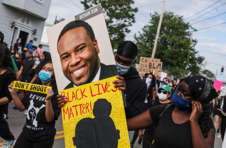 REVERE, MA - JUNE 9: A demonstrator holds a sign for Botham Jean while marching during a demonstration on June 9, 2020 in Revere, MA for George Floyd and other Black Americans killed at the hands of law enforcement. The peaceful march was been planned by Black and Brown Youth, a group based in Revere, who have come together to form Black Lives Matter Revere.