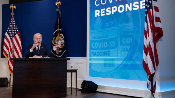 WASHINGTON, DC - JANUARY 13: U.S. President Joe Biden gestures as he gives remarks on his administration's response to the surge in COVID-19 cases across the country from the South Court Auditorium in the Eisenhower Executive Office Building on January 13, 2022 in Washington, DC. During the remarks President Biden urged unvaccinated individuals to seek the vaccine and highlighted his plan to distribute free COVID-19 tests and masks to the American people.