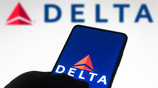 BRAZIL - 2021/11/10: In this photo illustration the Delta Air Lines logo seen displayed on a smartphone screen and in the background.