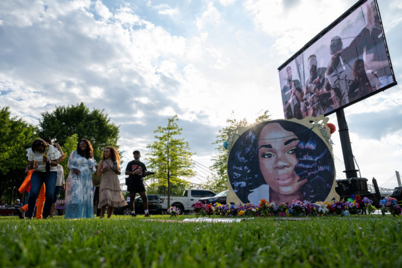 LOUISVILLE, KY - JUNE 05: People stand and laugh near an art installation depicting Breonna Taylor during the "Praise in the Park" event at the Big Four Lawn on June 5, 2021 in Louisville, Kentucky. The event commemorated what would have been Breonna Taylor’s 28th birthday. Taylor was a Black woman killed by police during a botched drug raid on her apartment on March 13, 2020, which sparked nationwide protests.