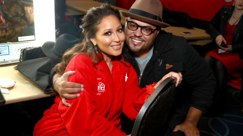 NEW YORK, NY - FEBRUARY 08: Actor Adrienne Houghton (L) and Israel Houghton pose backstage at the American Heart Association's Go Red For Women Red Dress Collection 2018 presented by Macy's at Hammerstein Ballroom on February 8, 2018 in New York City.