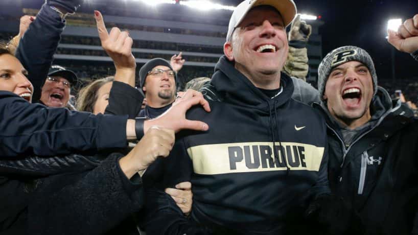 Jeff Brohm and the crowd storm the field