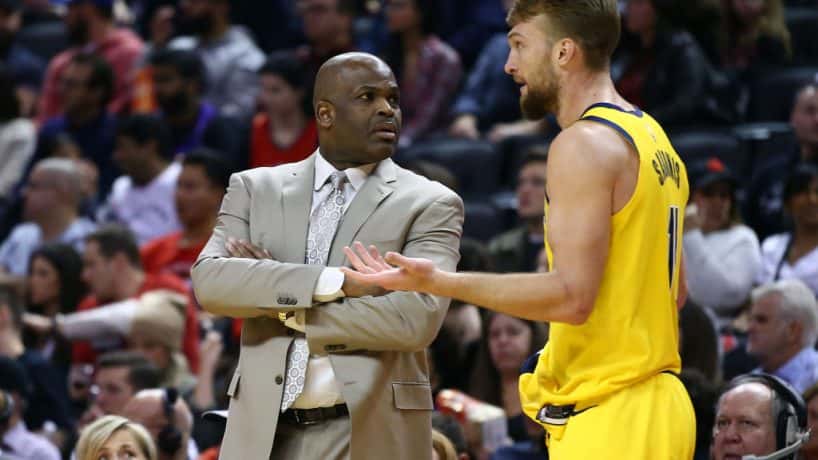 Pacers head coach Nate McMillan and forward Domantas Sabonis talk during a 2020 road loss.