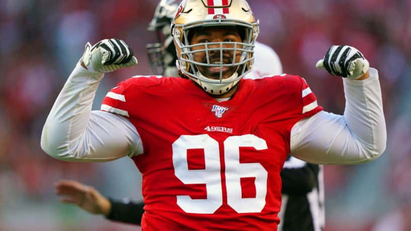 Former 49ers defensive lineman Sheldon Day flexes after making a play.