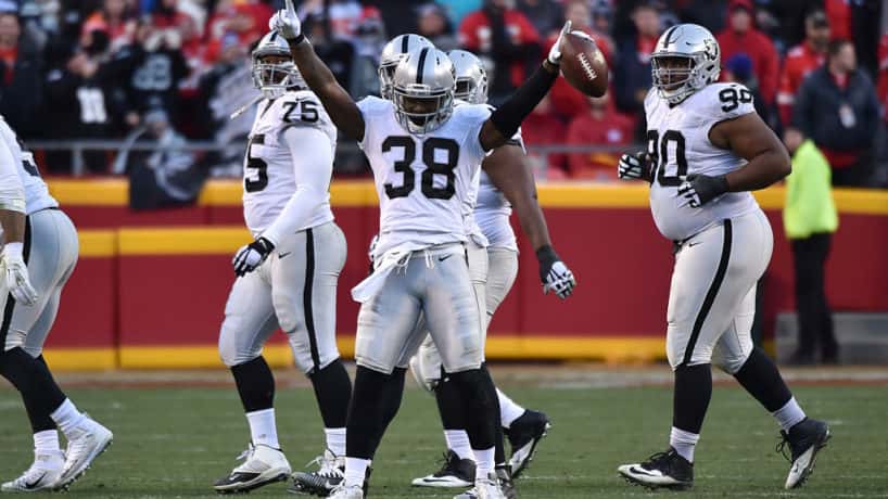 Former Raiders cornerback T.J. Carrie celebrates after a big play.