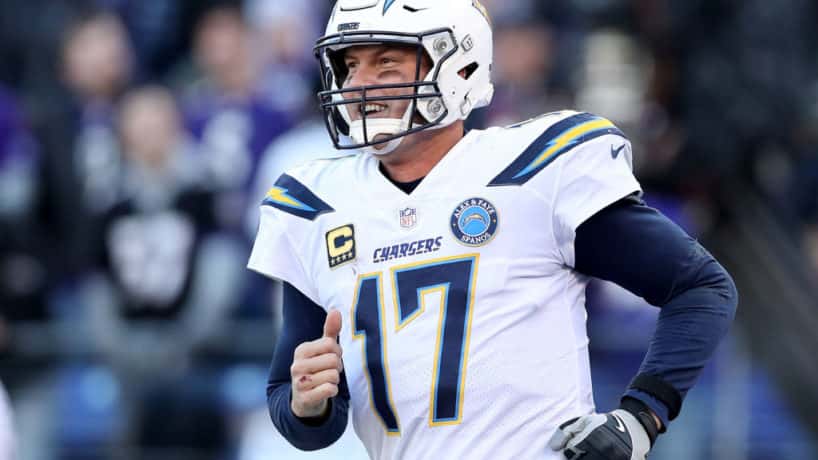 Former Chargers quarterback Philip Rivers runs out of the tunnel.
