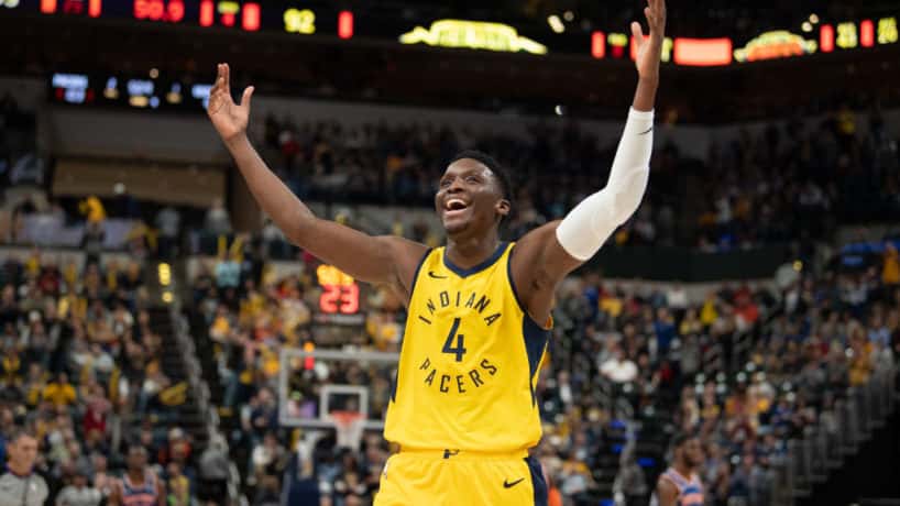 Pacers guard Victor Oladipo raises his hands to the crowd.