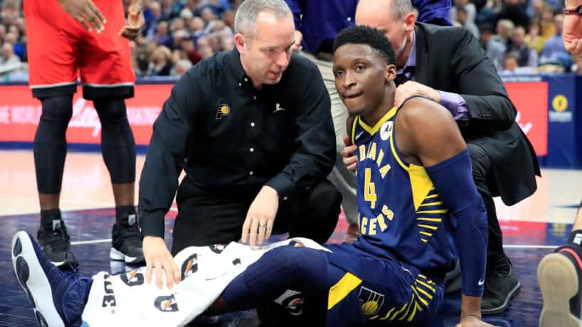 Pacers guard Victor Oladipo sits on the floor hurt.