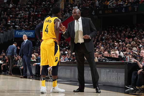 Pacers coach Nate McMillan talks to Victor Oladipo during a game.