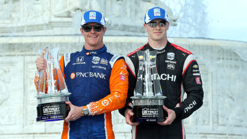 Scott Dixon and Josef Newgarden stand with trophies together on the podium in 2019