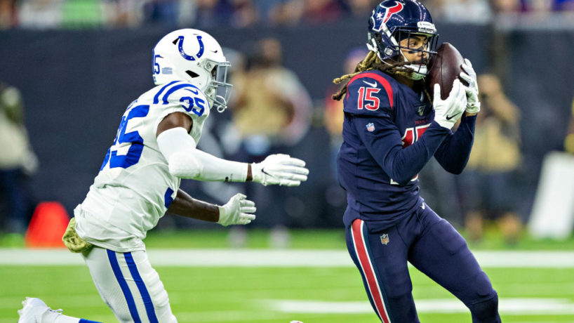 Houston Texans wide receiver Will Fuller catches a pass with a Colts defender coming to his left to tackle him