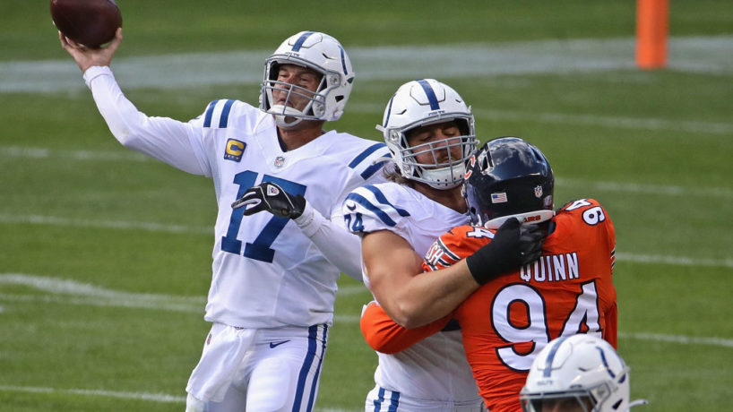 Philip Rivers launches a pass with Anthony Castonzo blocking a Chicago Bears edge rusher in front of him