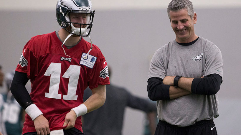 Carson Wentz and Frank Reich talk during practice.