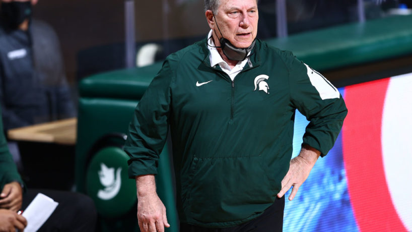 Tom Izzo watches his Michigan State team on the sideline with one hand on his hip