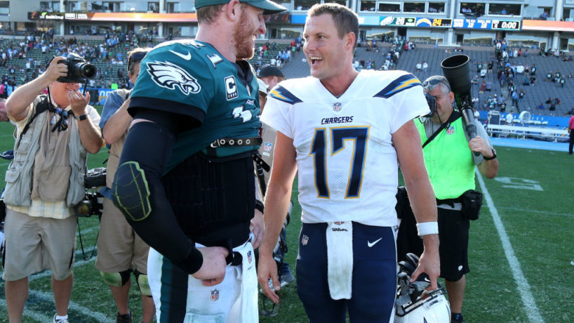 Carson Wentz and Philip Rivers talk after a game.