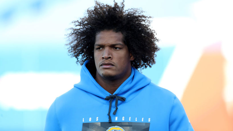 Isaac Rochell walks on the field before a game.