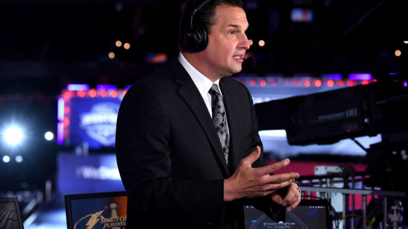 Eddie Olcyzk on camera talks through his headset during an NBC Hockey Broadcast