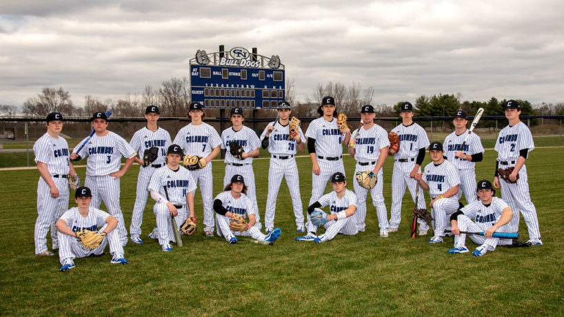 The Columbus North Baseball team poses in front of the scoreboard on their field