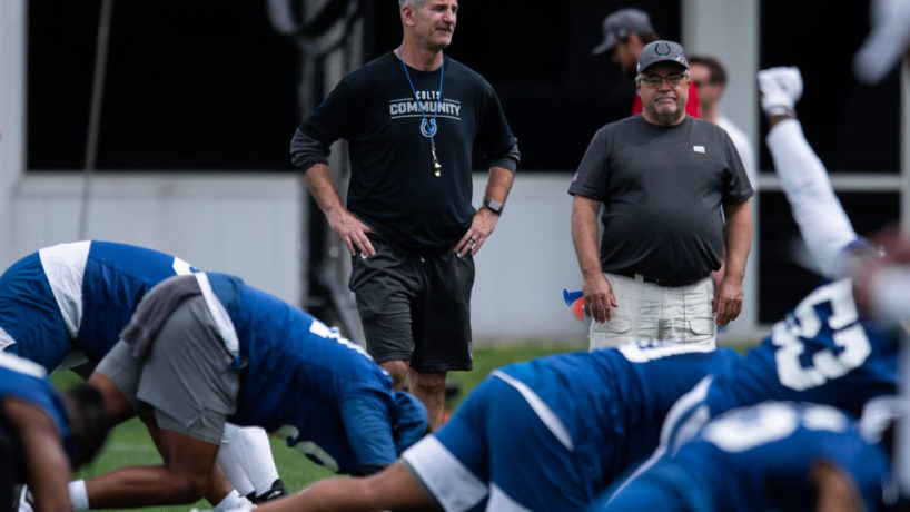 Frank Reich talks with his team before practice.
