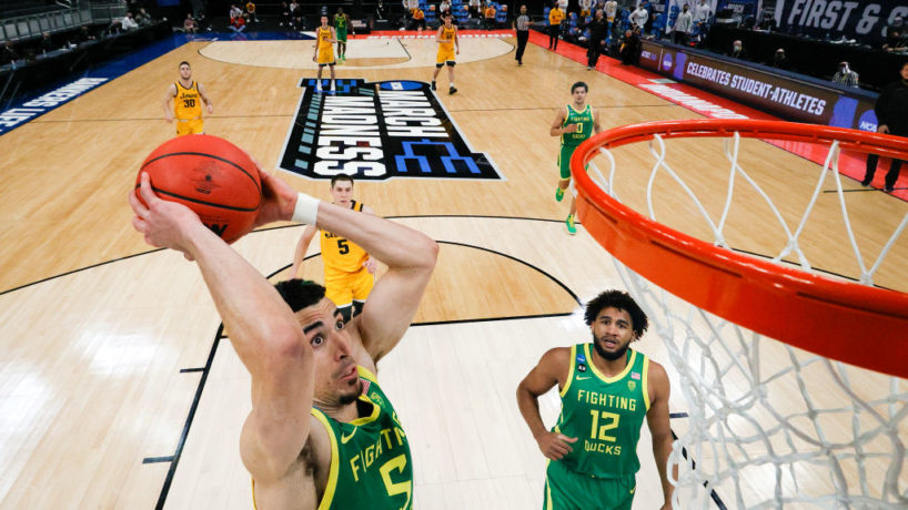 During March Madness, Chris Duarte goes up and slams a dunk with his Oregon teammates and opponents watch from behind