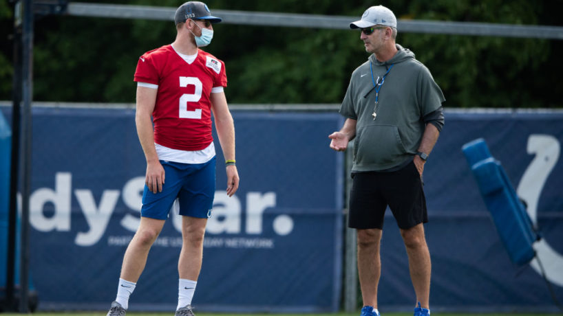 Carson Wentz chats with Frank Reich before practice.