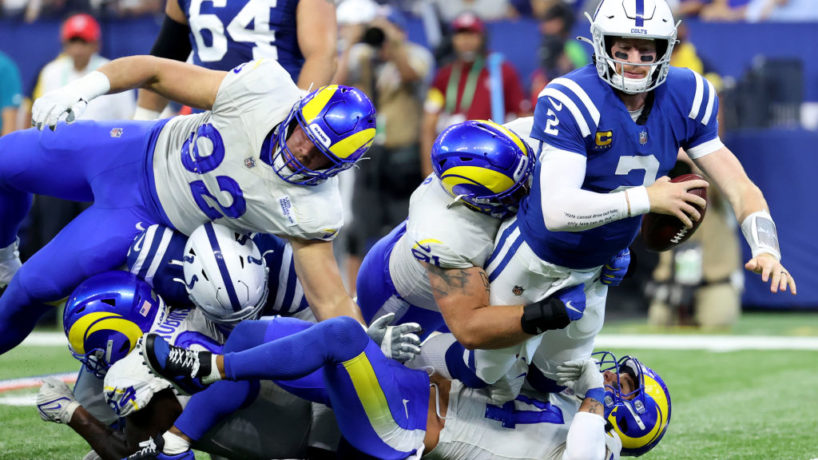 INDIANAPOLIS, INDIANA - SEPTEMBER 19: Safety Taylor Rapp #24 and defensive tackle Greg Gaines #91 of the Los Angeles Rams tackle quarterback Carson Wentz #2 of the Indianapolis Colts in the first half of the game at Lucas Oil Stadium on September 19, 2021 in Indianapolis, Indiana. (Photo by Andy Lyons/Getty Images)