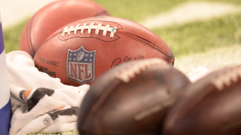 NFL footballs laying on field