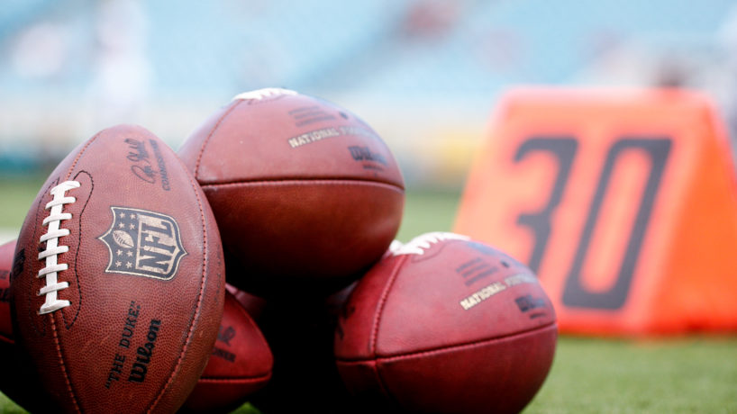 Pile of NFL footballs