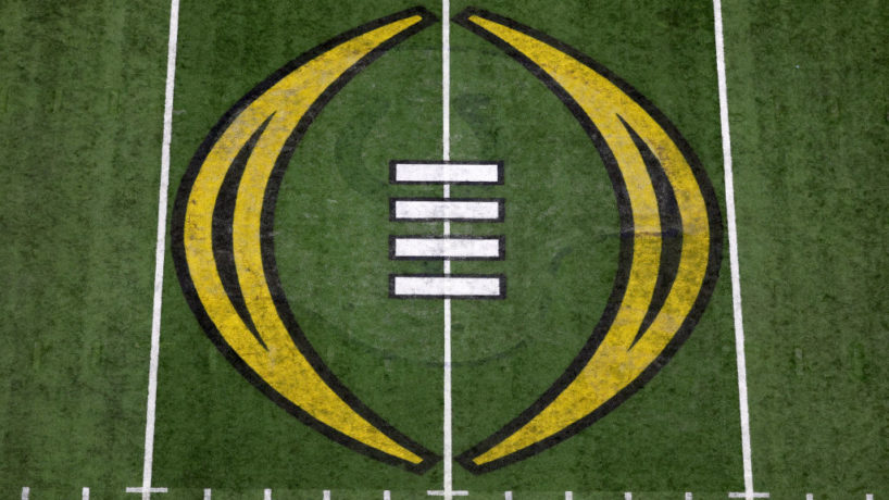 A close up shot of midfield and the College Football Playoff logo in the middle of Lucas Oil Stadium