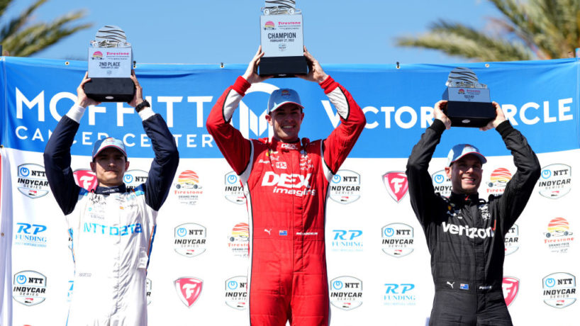 Scott McLaughlin, Alex Palou and Will Power pose with their trophies on the podium following the Firestone Grand Prix of St Petersburg