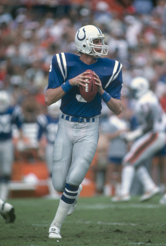 Mark Herrmann #9 of the Baltimore Colts looks to pass against the Miami Dolphins during an NFL football game November 20, 1983
