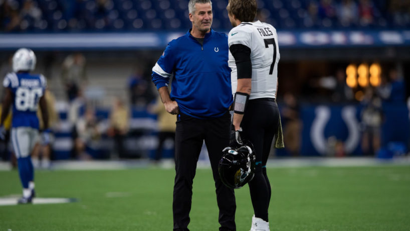 Frank Reich and Nick Foles chat before a game.