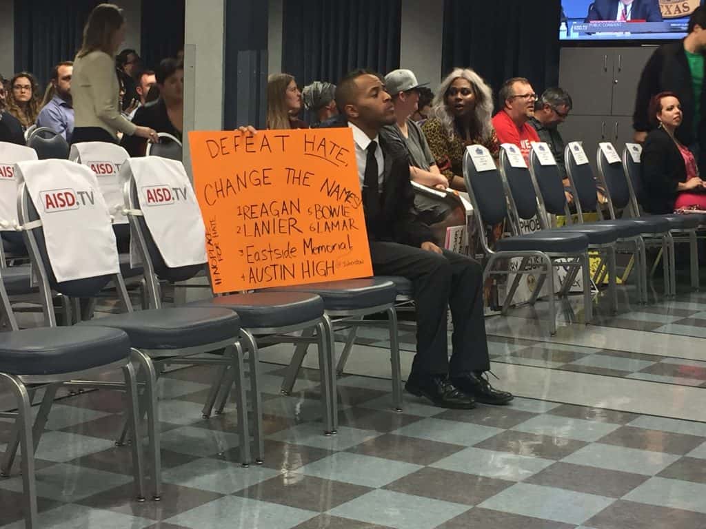 protester with AISD names