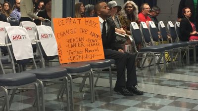 protester with AISD names