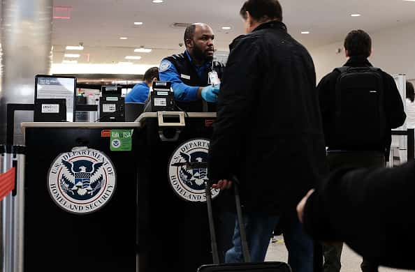 A Transportation Security Administration worker screens passengers at an airport