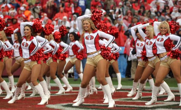 49ers cheerleader takes a knee during anthem before Raiders game