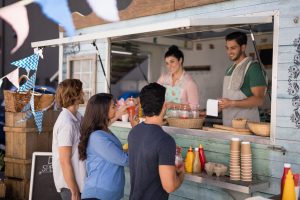 People being served at a food truck