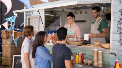 People being served at a food truck
