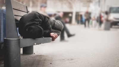 Person sleeping on bench