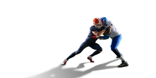 Two football players tackling each other